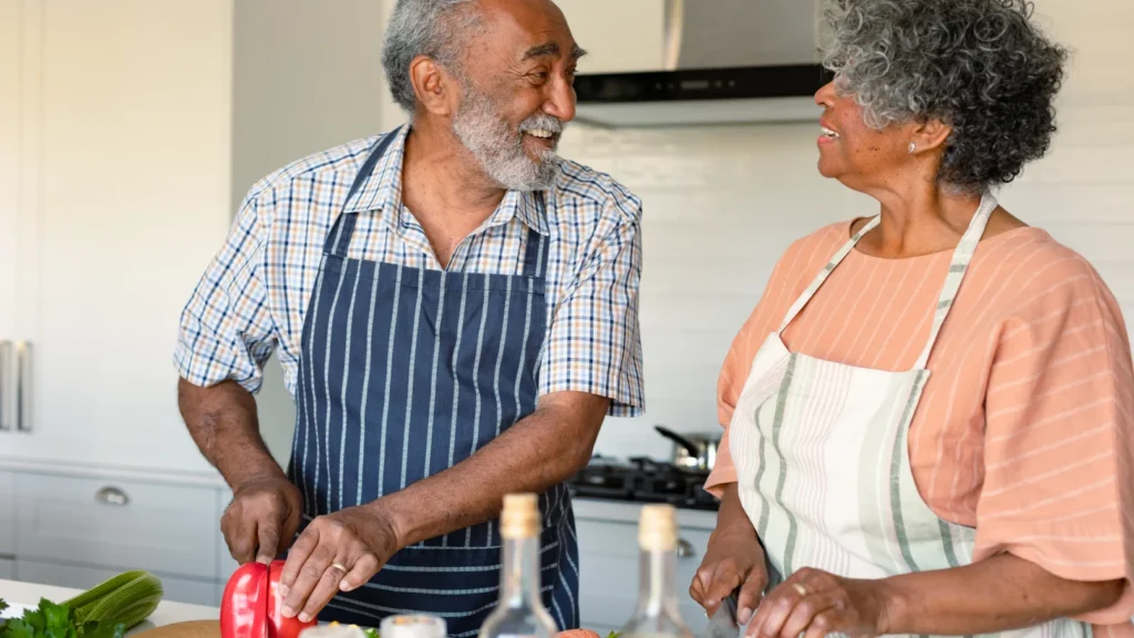 elderly couple cooking together