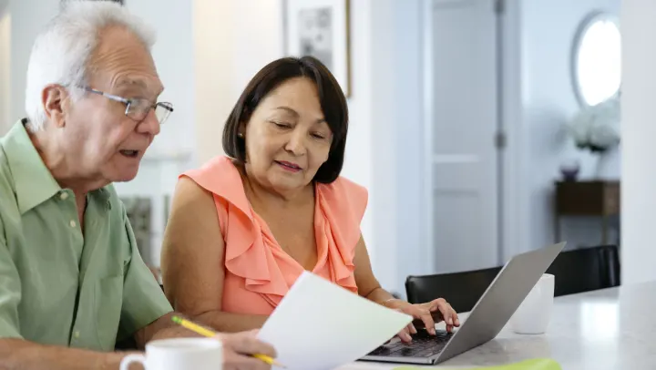 elderly couple looking at a piece of paper