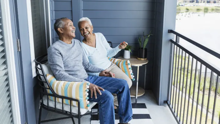 elderly couple enjoying each others company on the balcony
