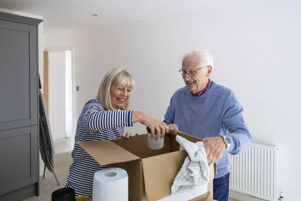 Senior man unpacking with adult daughter