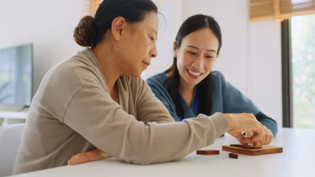 senior woman and caretaker playing game